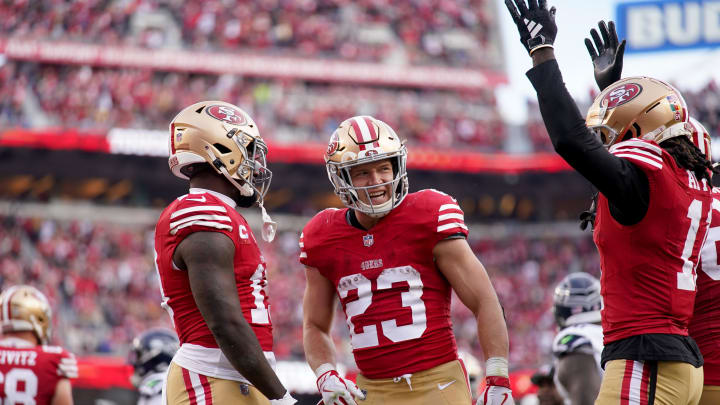 Dec 10, 2023; Santa Clara, California, USA; San Francisco 49ers running back Christian McCaffrey (23) stands next to wide receiver Deebo Samuel (19) and wide receiver Brandon Aiyuk (11) after the 49ers picked up a first down near the end zone against the Seattle Seahawks in the third quarter at Levi's Stadium. Mandatory Credit: Cary Edmondson-USA TODAY Sports