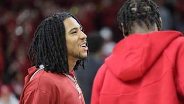 Mar 8, 2025; Fayetteville, Arkansas, USA; Arkansas Razorbacks guard Boogie Fland talks to forward Adou Thiero prior to the game against the Mississippi State Bulldogs at Bud Walton Arena. Mandatory Credit: Nelson Chenault-Imagn Images