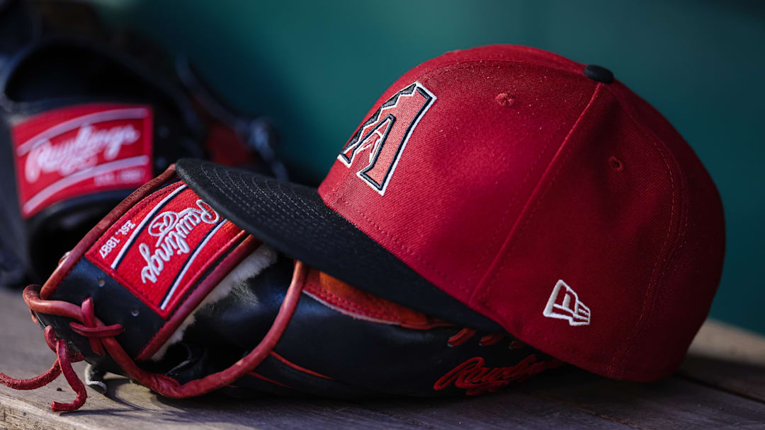 Jun 7, 2023; Washington, District of Columbia, USA; A general view of an Arizona Diamondbacks hat and Rawlings glove in the dugout during the fifth inning of the game against the Washington Nationals at Nationals Park. Mandatory Credit: Scott Taetsch-Imagn Images