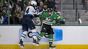 Dec 1, 2024; Dallas, Texas, USA; Dallas Stars center Colin Blackwell (15) checks Winnipeg Jets defenseman Haydn Fleury (24) during the third period at the American Airlines Center. Mandatory Credit: Jerome Miron-Imagn Images