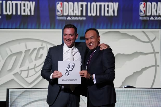 May 16, 2023; Chicago, IL, USA; NBA Deputy Commissioner Mark Tatum (right) congratulates San Antonio Spurs owner Peter J. Holt after his team won the NBA Draft Lottery.