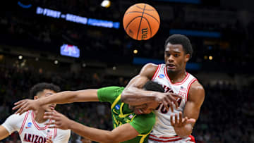Mar 23, 2025; Seattle, WA, USA;  Oregon Ducks forward Kwame Evans Jr. (10) and Arizona Wildcats forward Tobe Awaka (30) collide as they battle for the loose ball in the first half at Climate Pledge Arena. Mandatory Credit: Steven Bisig-Imagn Images