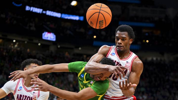 Mar 23, 2025; Seattle, WA, USA;  Oregon Ducks forward Kwame Evans Jr. (10) and Arizona Wildcats forward Tobe Awaka (30) collide as they battle for the loose ball in the first half at Climate Pledge Arena. Mandatory Credit: Steven Bisig-Imagn Images