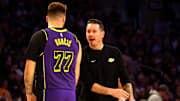 Feb 28, 2025; Los Angeles, California, USA; Los Angeles Lakers head coach JJ Redick talks to guard Luka Doncic (77) during the second quarter against the LA Clippers at Crypto.com Arena. Mandatory Credit: Jason Parkhurst-Imagn Images