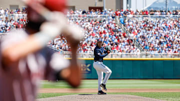 Jun 26, 2022; Omaha, NE, USA; Ole Miss pitcher Hunter Elliott (26) pitches while Oklahoma infielder Wallace Clark (6) waits during the first inning at Charles Schwab Field. Mandatory Credit: Jaylynn Nash-Imagn Images