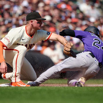 Colorado Rockies third baseman Ryan McMahon (24) slides into third base with an RBI triple against the San Francisco Giants during the eighth inning at Oracle Park on May 4.