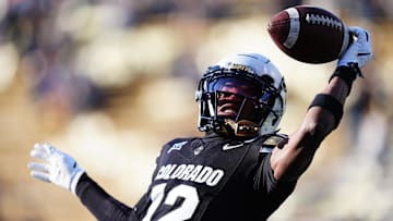 Nov 29, 2024; Boulder, Colorado, USA; Colorado Buffaloes wide receiver Travis Hunter (12) warms up before the game against the Oklahoma State Cowboys at Folsom Field. Mandatory Credit: Ron Chenoy-Imagn Images