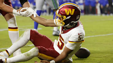 Nov 2, 2025; Landover, Maryland, USA; Washington Commanders quarterback Jayden Daniels (5) is injured on a play during the second half against the Seattle Seahawks at Northwest Stadium. Mandatory Credit: Amber Searls-Imagn Images