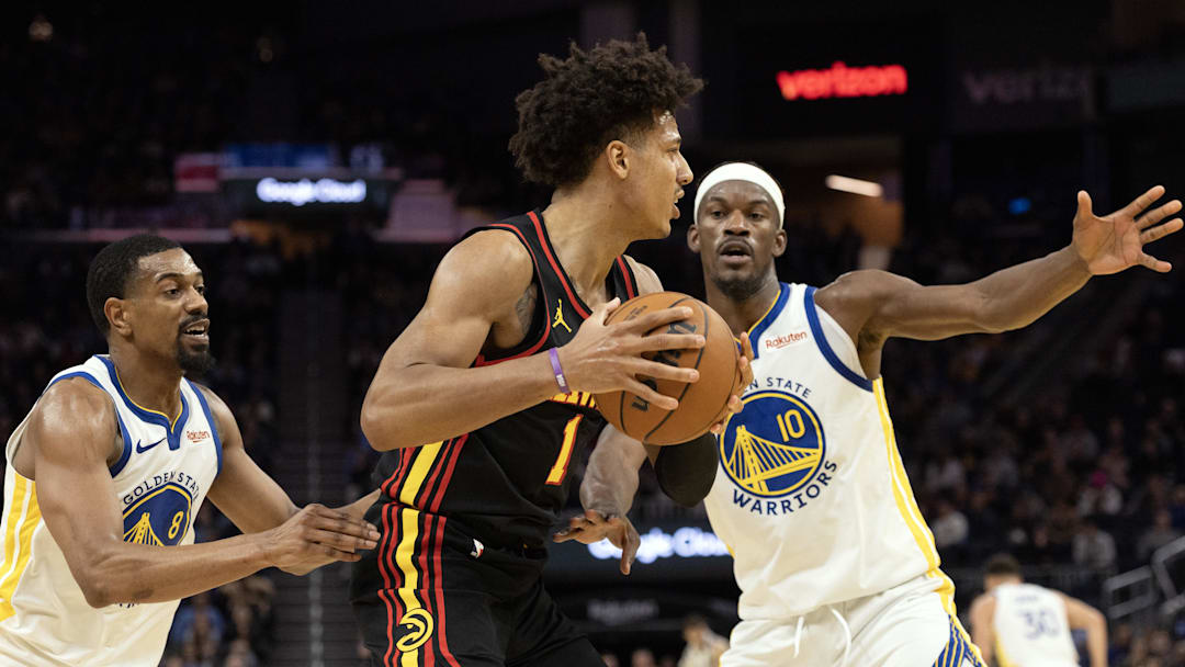 Jan 11, 2026; San Francisco, California, USA; Atlanta Hawks forward Jalen Johnson (1) looks for an open teammate as he is double-teamed by Golden State Warriors guard De'Anthony Melton (8) and forward Jimmy Butler III (10) during the fourth quarter at Chase Center. Mandatory Credit: D. Ross Cameron-Imagn Images