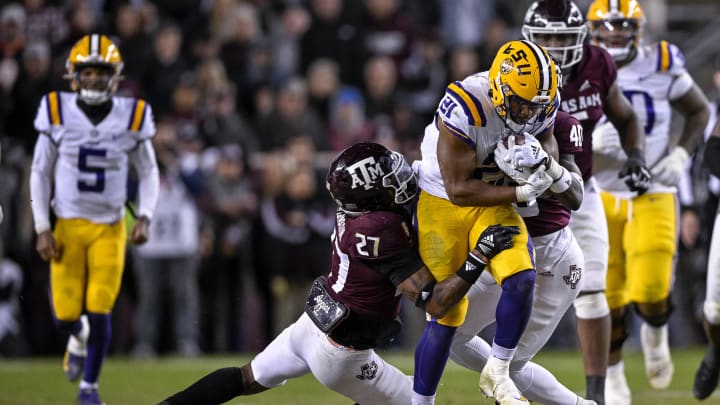 Nov 26, 2022; College Station, Texas, USA; Texas A&M Aggies defensive back Antonio Johnson (27) and LSU Tigers running back Noah Cain (21) in action during the game between the Texas A&M Aggies and the LSU Tigers at Kyle Field. Mandatory Credit: Jerome Miron-USA TODAY Sports