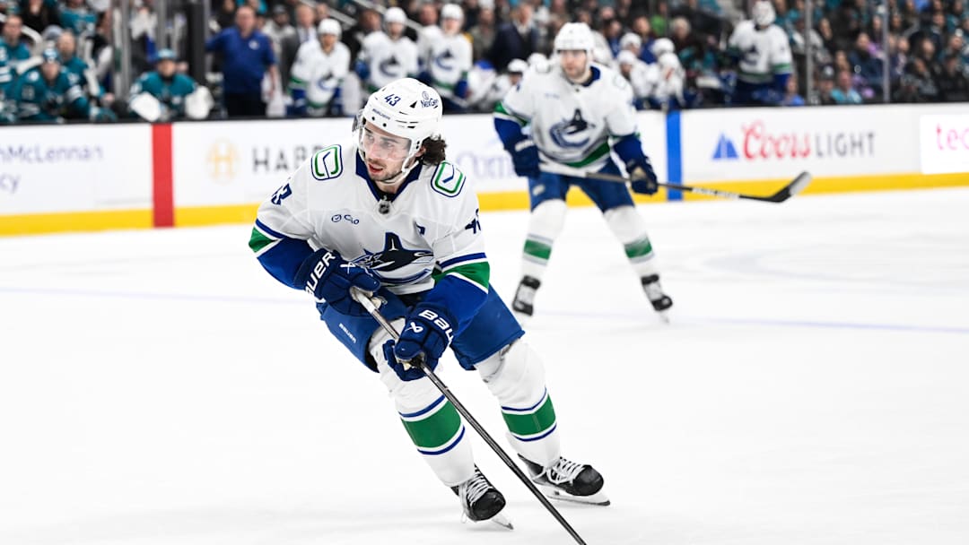Nov 28, 2025; San Jose, California, USA; Vancouver Canucks defenseman Quinn Hughes (43) controls the puck against the San Jose Sharks in the third period at SAP Center at San Jose. Mandatory Credit: Eakin Howard-Imagn Images