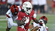 Sep 6, 2025; Pullman, Washington, USA; Washington State Cougars running back Angel Johnson (1) is tackled by San Diego State Aztecs safety Eric Butler (6) in the first half at Gesa Field at Martin Stadium. Mandatory Credit: James Snook-Imagn Images