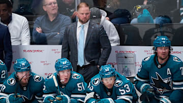 Oct 9, 2025; San Jose, California, USA; San Jose Sharks head coach Ryan Warsofsky watches game play against the Vegas Golden Knights with center Ty Dellandrea (10), right wing Collin Graf (51), left wing Jeff Skinner (53) and center Tyler Toffoli (73) during the second period at SAP Center at San Jose. Mandatory Credit: Robert Edwards-Imagn Images