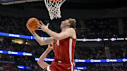 Mar 15, 2025; Nashville, TN, USA;  Alabama Crimson Tide forward Grant Nelson (4) lays the ball in over  Florida Gators forward Alex Condon (21) during the first half at Bridgestone Arena. Mandatory Credit: Steve Roberts-Imagn Images
