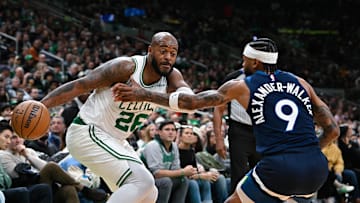Nov 24, 2024; Boston, Massachusetts, USA; Boston Celtics forward Xavier Tillman (26) drives the ball against Minnesota Timberwolves guard Nickeil Alexander-Walker (9) during the first half at TD Garden. Mandatory Credit: Eric Canha-Imagn Images