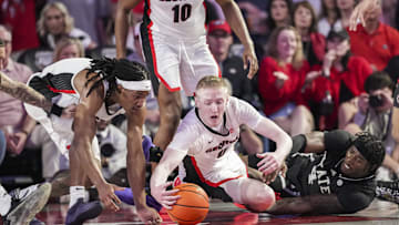 Feb 8, 2025; Athens, Georgia, USA; Georgia Bulldogs guards Silas Demary Jr. (5) and Blue Cain (0) fight for the ball with Mississippi State Bulldogs forward Cameron Matthews (4) during the first half at Stegeman Coliseum. Mandatory Credit: Dale Zanine-Imagn Images