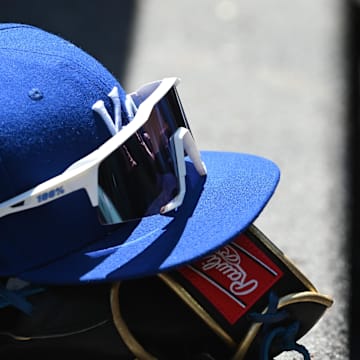 May 9, 2022; Baltimore, Maryland, USA;  A detailed view of Kansas City Royals hat and glove in the dugout during the first inning against the Baltimore Orioles at Oriole Park at Camden Yards. Mandatory Credit: Tommy Gilligan-Imagn Images