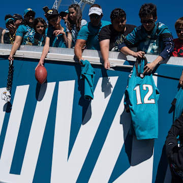 Jacksonville Jaguars wide receiver Travis Hunter (12) autographs a jersey before an NFL football game at EverBank Stadium, Sunday, Oct. 12, 2025, in Jacksonville, Fla.
