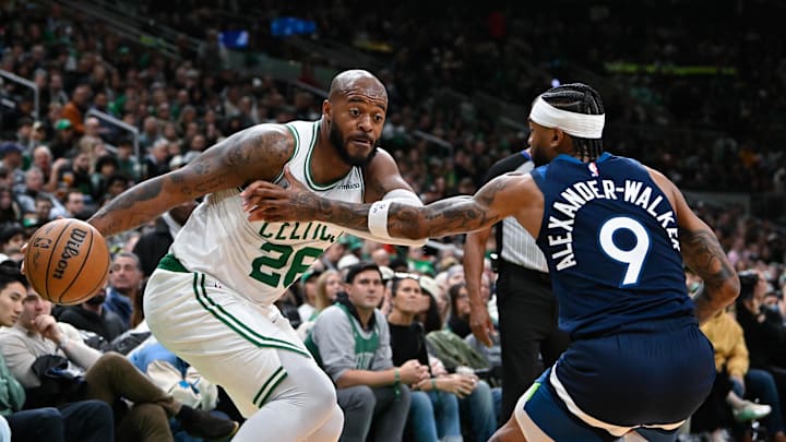Nov 24, 2024; Boston, Massachusetts, USA; Boston Celtics forward Xavier Tillman (26) drives the ball against Minnesota Timberwolves guard Nickeil Alexander-Walker (9) during the first half at TD Garden. Mandatory Credit: Eric Canha-Imagn Images