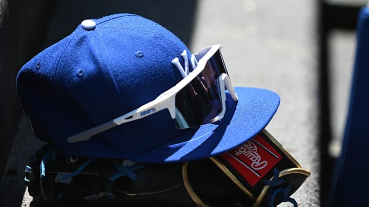 May 9, 2022; Baltimore, Maryland, USA;  A detailed view of Kansas City Royals hat and glove in the dugout during the first inning against the Baltimore Orioles at Oriole Park at Camden Yards. Mandatory Credit: Tommy Gilligan-Imagn Images