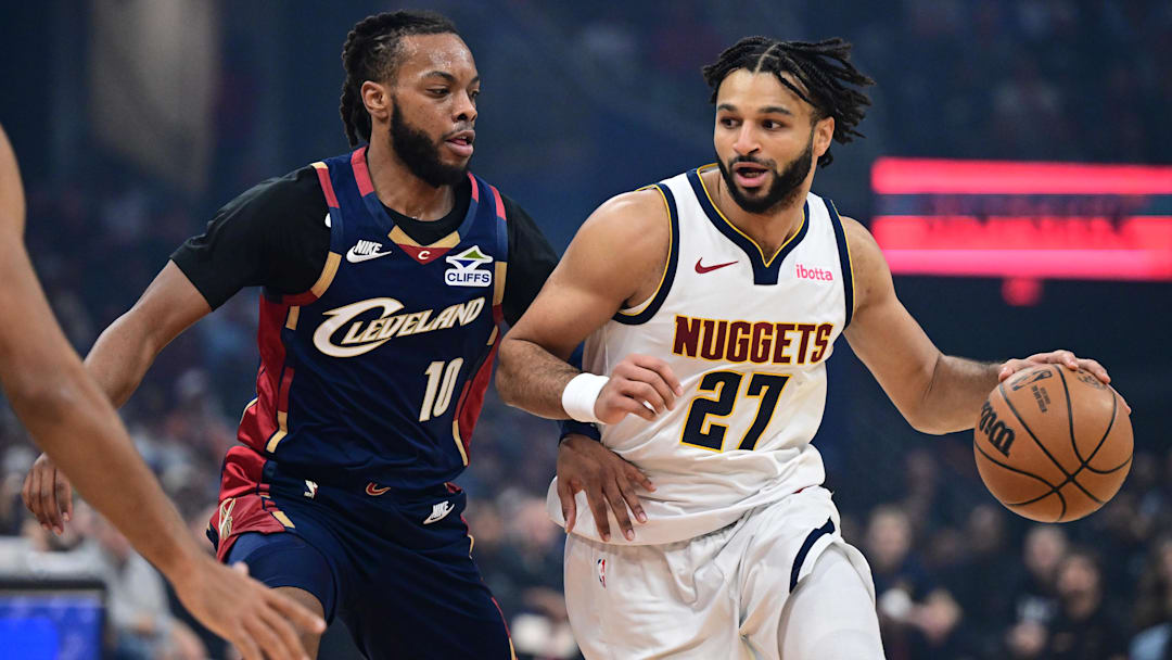 Jan 2, 2026; Cleveland, Ohio, USA; Denver Nuggets guard Jamal Murray (27) drives on Cleveland Cavaliers guard Darius Garland (10) during the first half at Rocket Arena. Mandatory Credit: David Dermer-Imagn Images