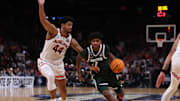 Michigan State Spartans guard Jase Richardson (11) drives against Auburn Tigers center Dylan Cardwell (44) during the second half in the South Regional final of the 2025 NCAA tournament at State Farm Arena. 