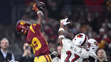 Dec 27, 2023; San Diego, CA, USA; USC Trojans wide receiver Ja'Kobi Lane (89) catches a touchdown pass over Louisville Cardinals defensive back Devin Neal (27) during the second half at Petco Park. Mandatory Credit: Orlando Ramirez-USA TODAY Sports