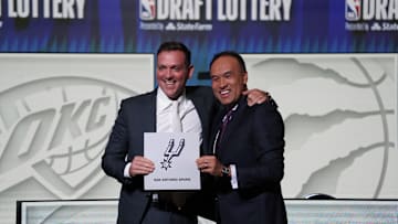 May 16, 2023; Chicago, IL, USA; NBA Deputy Commissioner Mark Tatum (right) congratulates San Antonio Spurs managing partner Peter J. Holt (left) the first pick in the 2023 NBA Draft Lottery at McCormick Place West. Mandatory Credit: David Banks-Imagn Images
