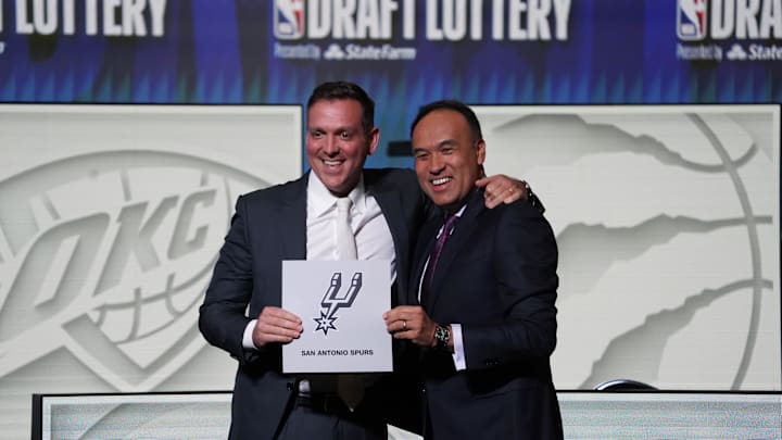 May 16, 2023; Chicago, IL, USA; NBA Deputy Commissioner Mark Tatum (right) congratulates San Antonio Spurs managing partner Peter J. Holt (left) the first pick in the 2023 NBA Draft Lottery at McCormick Place West. Mandatory Credit: David Banks-Imagn Images