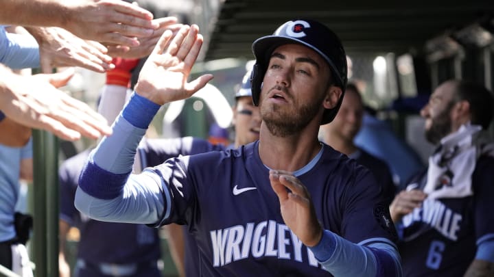 Jul 5, 2024; Chicago, Illinois, USA; Chicago Cubs outfielder Cody Bellinger (24) is greeted after scoring against the Los Angeles Angels during the first inning at Wrigley Field.