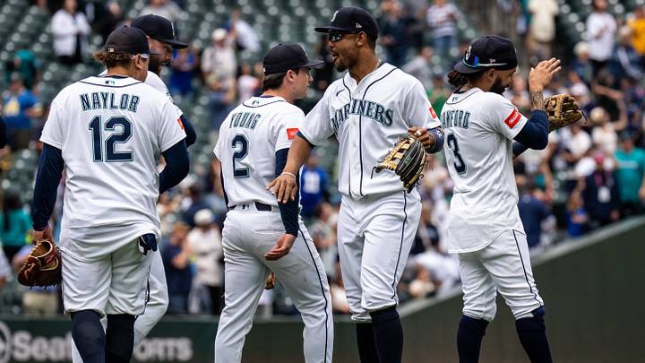 Sep 10, 2026; Seattle, Washington, USA;  Seattle Mariners, from left, Josh Naylor (12), second baseman Cole Young (2) centerfielder Julio Rodriguez (44) and shortstop J.P. Crawford (3) celebrate aafter a game against the Texas Rangers at T-Mobile Park. Mandatory Credit: Stephen Brashear-Imagn Images