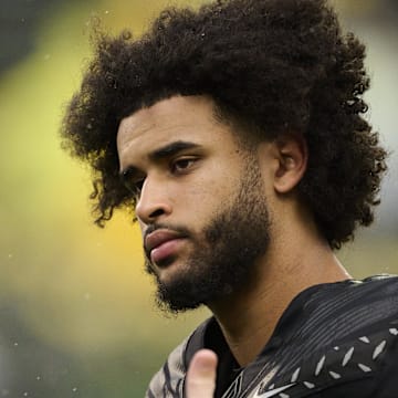 Oct 25, 2025; Eugene, Oregon, USA; Oregon Ducks quarterback Dante Moore (5) talks to officials during warm ups before a game against the Wisconsin Badgers at Autzen Stadium. The Ducks are wearing uniforms celebrating the Grateful Dead. Mandatory Credit: Troy Wayrynen-Imagn Images