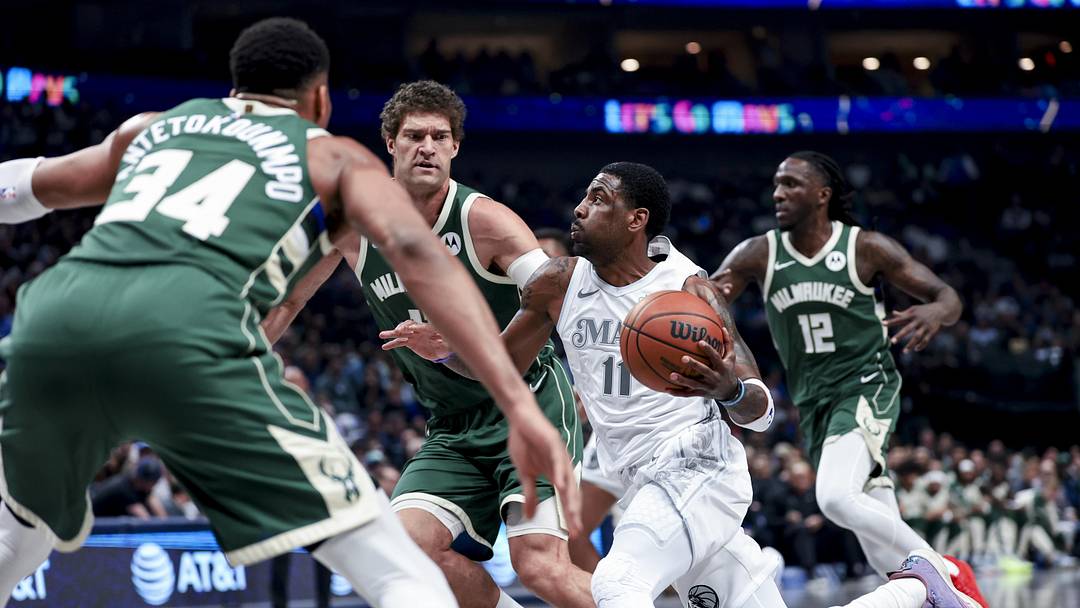 Mar 1, 2025; Dallas, Texas, USA;  Dallas Mavericks guard Kyrie Irving (11) drives to the basket as Milwaukee Bucks center Brook Lopez (11) and Milwaukee Bucks forward Giannis Antetokounmpo (34) defend during the first half at American Airlines Center. Mandatory Credit: Kevin Jairaj-Imagn Images