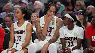 Aug 17, 2025; San Francisco, California, USA;  Atlanta Dream forward Nia Coffey (12), center Brittney Griner (42), and guard Maya Caldwell (33) sit on the bench in the second quarter during a game against the Golden State Valkyries at Chase Center. Mandatory Credit: David Gonzales-Imagn Images
