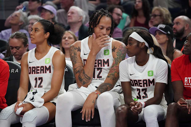 Atlanta Dream forward Nia Coffey, center Brittney Griner, and guard Maya Caldwell sit on the bench.