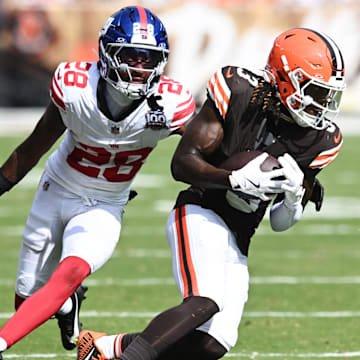 Sep 22, 2024; Cleveland, Ohio, USA; Cleveland Browns wide receiver Jerry Jeudy (3) runs with the ball after a catch as New York Giants cornerback Cor'Dale Flott (28) defends during the second half at Huntington Bank Field. Mandatory Credit: Ken Blaze-Imagn Images