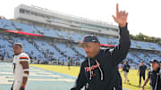 Oct 25, 2025; Chapel Hill, North Carolina, USA; Virginia Cavaliers head coach Tony Elliott runs off the field after defeating the North Carolina Tar Heels in overtime at Kenan Stadium. Mandatory Credit: Bob Donnan-Imagn Images