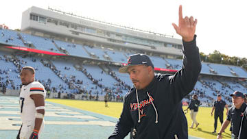 Oct 25, 2025; Chapel Hill, North Carolina, USA; Virginia Cavaliers head coach Tony Elliott runs off the field after defeating the North Carolina Tar Heels in overtime at Kenan Stadium. Mandatory Credit: Bob Donnan-Imagn Images