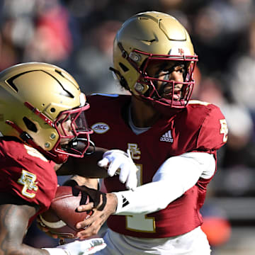Nov 9, 2024; Chestnut Hill, Massachusetts, USA; Boston College Eagles quarterback Thomas Castellanos (1) hands the ball off to unning back Kye Robichaux (5) during the first half at Alumni Stadium. Mandatory Credit: Brian Fluharty-Imagn Images