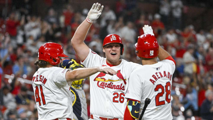 Aug 21, 2024; St. Louis, Missouri, USA;  St. Louis Cardinals pinch hitter Luken Baker (26) is congratulated by right fielder Alec Burleson (41) and third baseman Nolan Arenado (28) after hitting a two run home run against the Milwaukee Brewers during the seventh inning at Busch Stadium. Mandatory Credit: Jeff Curry-USA TODAY Sports