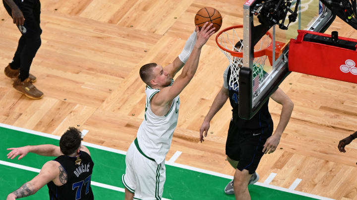 Jun 6, 2024; Boston, Massachusetts, USA; Boston Celtics center Kristaps Porzingis (8) dunks against the Dallas Mavericks during the second half of game one of the 2024 NBA Finals at TD Garden. Mandatory Credit: Peter Casey-USA TODAY Sports