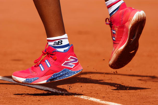 Coco Gauff's red, white, and blue New Balance tennis shoes.