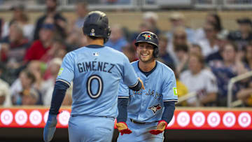 Jun 6, 2025; Minneapolis, Minnesota, USA; Toronto Blue Jays third baseman Ernie Clement (22) and Toronto Blue Jays second baseman Andres Gimenez (0) celebrate after scoring the go ahead runs against the Minnesota Twins in the fifth inning at Target Field. Mandatory Credit: Jesse Johnson-Imagn Images