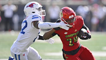 Oct 5, 2024; Louisville, Kentucky, USA;  Louisville Cardinals wide receiver Ahmari Huggins-Bruce (24) runs the ball against Southern Methodist Mustangs safety Cale Sanders Jr. (22) during the second half at L&N Federal Credit Union Stadium. Mandatory Credit: Jamie Rhodes-Imagn Images
