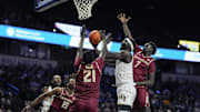 Feb 12, 2025; Winston-Salem, North Carolina, USA; Wake Forest Demon Deacons forward Omaha Biliew (0) loses the ball at the rim against Florida State Seminoles forward Alier Maluk (21) during the first half at Lawrence Joel Veterans Memorial Coliseum. Mandatory Credit: Jim Dedmon-Imagn Images