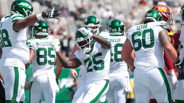 Aug 10, 2024; East Rutherford, New Jersey, USA; New York Jets running back Israel Abanikanda (25) celebrates his touchdown with teammates during the fourth quarter against the Washington Commanders at MetLife Stadium.