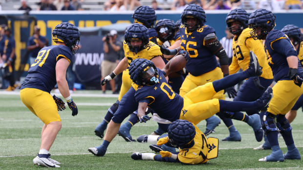 West Virginia University freshman defensive back Zae Jennings (17) cuts down redshirt junior Jalen Anderson (0) in the backfield of the Gold-Blue Spring Game