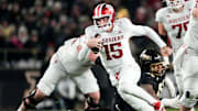 Indiana Hoosiers quarterback Fernando Mendoza (15) rushes up the field Friday, Nov. 28, 2025, during the 100th annual Old Oaken Bucket game at Ross-Ade Stadium in West Lafayette.