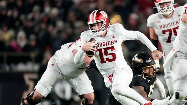 Indiana Hoosiers quarterback Fernando Mendoza (15) rushes up the field Friday, Nov. 28, 2025, during the 100th annual Old Oaken Bucket game at Ross-Ade Stadium in West Lafayette.