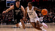 Xavier Musketeers guard Dante Maddox Jr. (21) drives on Cincinnati Bearcats guard Connor Hickman (8) in the second half of the NCAA Basketball game at Fifth Third Arena in Cincinnati on Saturday, Dec. 14, 2024. Cincinnati Bearcats defeated Xavier Musketeers 68-65.